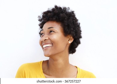 Closeup Portrait Of Happy Young African Woman Looking Away Against White Background
