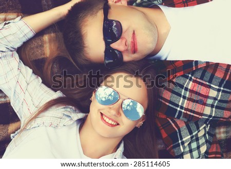 Similar – Two women with sunglasses smiling lying in blanket