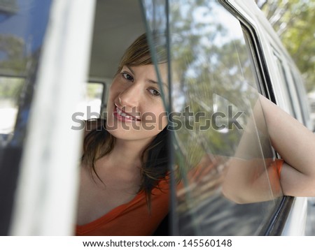 Closeup portrait of happy young woman in campervan during road trip