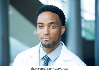 Closeup Portrait Head Shot Of Friendly, Smiling Confident Male Healthcare Professional With A White Coat, Isolated Hospital Clinic Background.