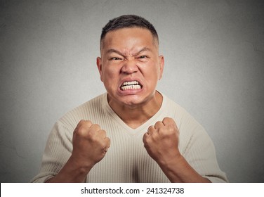 Closeup Portrait Headshot Angry Middle Aged Man With Open Mouth Fist Up In Air Aggressive Screaming Isolated Grey Wall Background. Negative Human Emotion Face Expression Feeling Body Language Reaction