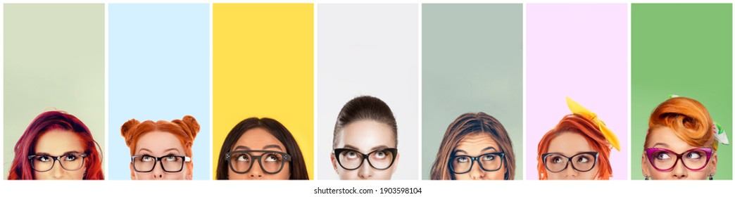 closeup portrait headshot cropped faces above lips of funny women in glasses looking up isolated on colorful studio wall background with copy space above head. Human face expressions, emotions