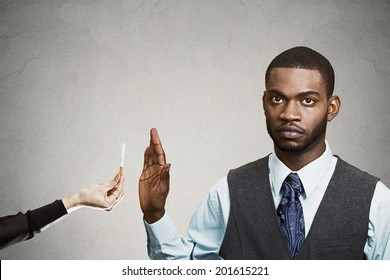 Closeup Portrait, Headshot Handsome Young Business Man Says No To Cigarette Offered By Person, Stop Hand Gesture, Isolated Black, Grey Background. Healthy Life Choices. Human Face Expression, Reaction