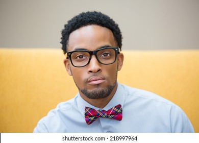 Closeup Portrait Headshot, High Iq, Intelligent Guy With Black Glasses And Bow Tie, Isolated Yellow White Background