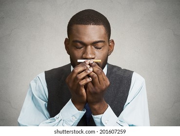 Closeup Portrait, Headshot, Young Handsome Business Man, Corporate Executive, Funny Looking Guy, Craving Cigarette, Tobacco, Isolated Black Grey Background. Bad, Dangerous Human Health Habits Concept