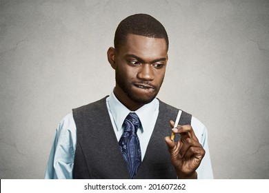 Closeup Portrait, Headshot, Young Handsome Business Man, Corporate Executive, Funny Looking Guy, Craving Cigarette, Tobacco, Isolated Black Grey Background. Bad, Dangerous Human Health Habits Concept