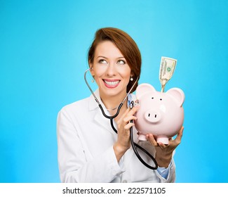 Closeup Portrait Health Care Professional Doctor Nurse Listening With Stethoscope To Piggy Bank, Dollar Bill Isolated Blue Background. Medical Insurance, Medicare Medicaid Reimbursement Reform Concept