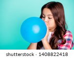 Close-up portrait of her she nice attractive cute charming wavy-haired girl in checked shirt blowing festive baloon fest isolated on bright vivid shine green blue turquoise background