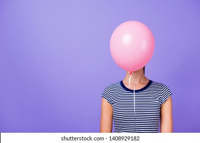 Close-up portrait of her she nice attractive funny girl closing face with pink helium ball concept isolated over violet purple vivid shine bright background