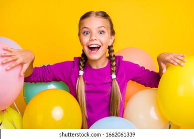 Close-up portrait of her she nice attractive lovely charming excited cheerful cheery girl among bunch balls isolated over bright vivid shine vibrant yellow color background