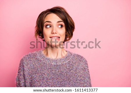 Close-up portrait of her she nice attractive lovely lovable pretty cute charming girlish funny unsure brown-haired girl biting lip looking aside isolated over pink pastel color background