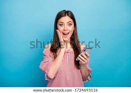Close-up portrait of her she nice attractive lovely pretty amazed cheerful cheery girl using cell browsing fast speed connection isolated over bright vivid shine vibrant blue color background
