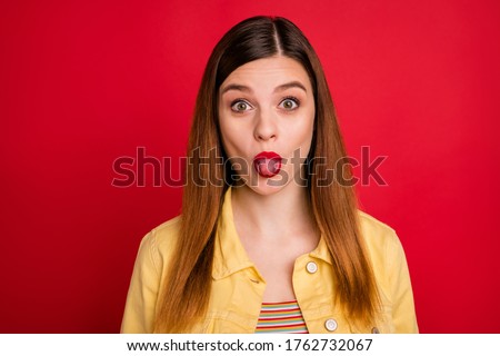 Close-up portrait of her she nice attractive lovely pretty cute funky cheerful cheery red-haired girl showing tongue out isolated on bright vivid shine vibrant red color background