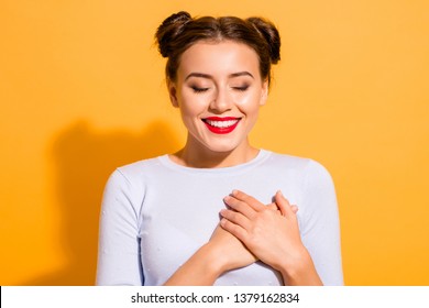 Close-up portrait of her she nice-looking attractive lovely peaceful sweet winsome cheerful glamorous girl touching heart meditating isolated over bright vivid shine yellow background