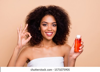 Close-up portrait of her she nice-looking attractive well-groomed cheerful wavy-haired girl holding in hands oil mask balsam showing ok-sign advert isolated over beige pastel background