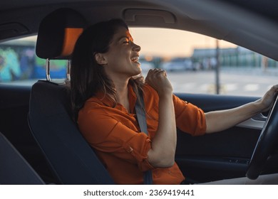 Close-up portrait of her she nice-looking attractive lovely brunette charming glad cheerful cheery girl riding new car enjoying having fun listening music singing pop rock