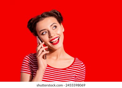 Close-up portrait of her she nice-looking cute attractive fascinating glamorous cheerful cheery girl wearing striped t-shirt talking on phone isolated over pink pastel background - Powered by Shutterstock