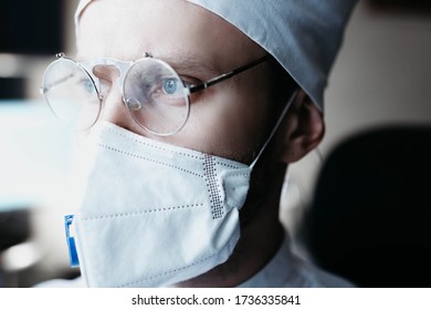 Closeup Portrait Of A Heroic Dramatic Doctor In Masked Glasses And Uniform.