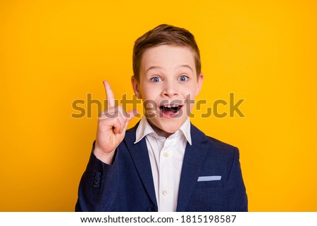 Close-up portrait of his he handsome intellectual cheerful cheery pre-teen boy find creating solution pointing up great idea isolated bright vivid shine vibrant yellow color background
