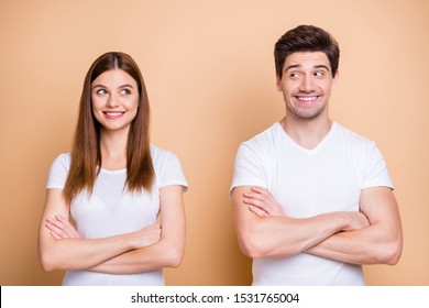 Close-up portrait of his he her she nice attractive cheerful cheery discontent shy couple wearing white t-shirt folded arms awkward meet isolated over beige pastel color background