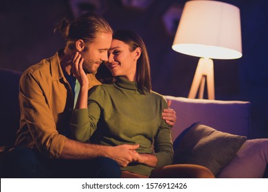 Close-up Portrait Of His He Her She Nice Attractive Lovely Affectionate Tender Lovable Cheerful Dreamy Couple Girl Sitting On Divan Spending Day Weekend Kissing At Night Dark Home House Apartment