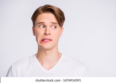 Close-up portrait of his he nice cute attractive worried uncertain guy looking aside oops mistake fail isolated over light white pastel background