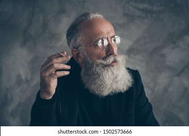 Close-up portrait of his he nice attractive content focused dreamy bewildered grey-haired top director manager thinking isolated over gray concrete wall background