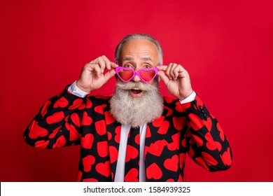 Close-up portrait of his he nice attractive comic humorous cheerful cheery modern trendy gray-haired guy wearing touching specs having fun isolated on bright vivid shine vibrant red color background - Shutterstock ID 1584939325