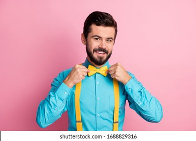 Close-up portrait of his he nice attractive cheerful cheery content imposing well-dressed bearded guy wearing festal mint blue shirt fixing bow-tie isolated over pastel pink color background