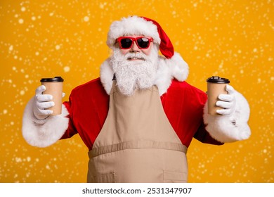 Close-up portrait of his he nice attractive cheerful cheery Santa waiter holding in hands two cups order latte beverage cacao giving order isolated bright vivid shine vibrant yellow color background - Powered by Shutterstock