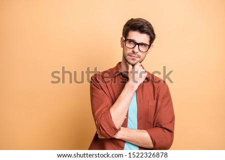 Close-up portrait of his he nice attractive serious focused minded brown-haired guy experienced professional financier economist thinking touching chin isolated over beige color pastel background [[stock_photo]] © 