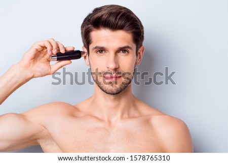 Close-up portrait of his he nice attractive bearded well-groomed perfect brown-haired guy cutting hair using cutter device modern grooming isolated on light white grey color pastel background