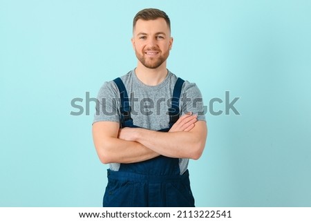 Close-up portrait of his he nice attractive cheerful cheery content guy repairer craftsman isolated over blue color background. Foto d'archivio © 