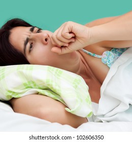 Close-up Portrait Of An Hispanic Woman Coughing And Resting In A Bed