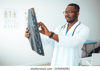 Closeup Portrait Of Intellectual Man Healthcare Personnel With White Labcoat, Looking At Full Body X-ray Radiographic Image, Ct Scan, Mri, Isolated Hospital Clinic Background. Radiology Department