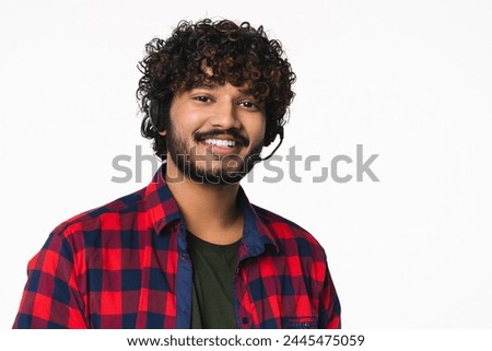 Closeup portrait of IT-support manager with headset isolated over white background. Young Indian Hindi dispatcher hot line worker consulting customers online