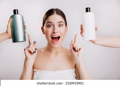 Closeup Portrait Of Joyful Girl Posing Without Makeup On White Background. Woman Chose Which Shampoo Is Best To Use