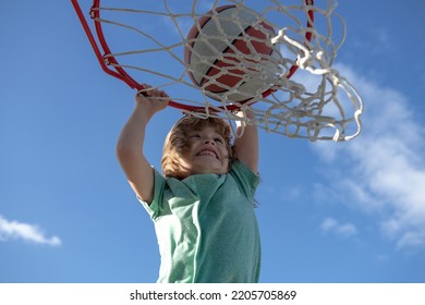 Closeup Portrait Of Kid Basketball Player Making Slam Dunk During Basketball Game.