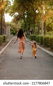 Closeup portrait of a little baby girl and mother on wheat summer park. Happy childhood concept. Adventure, travel, tourism, hike and people concept - happy family walking - Shutterstock ID 2177806847