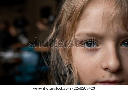 close-up portrait of a little girl with blond hair. horizontal