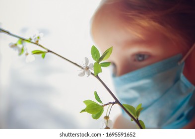 Closeup Portrait Of A Little Girl In A Medical Mask. Home Quarantine. Quarantine Fatigue Concept 