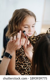 Closeup Portrait Of Little Girl She Prepared For A Photo Shoot, Makeup Artist At Work. 