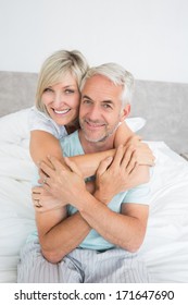 Close-up Portrait Of A Loving Mature Couple In Bed At Home