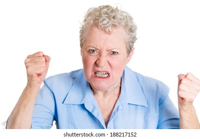 Closeup portrait, mad, angry, upset, hostile, senior mature woman, worker, furious employee, fists in air, isolated white background. Negative emotions, facial expression reaction