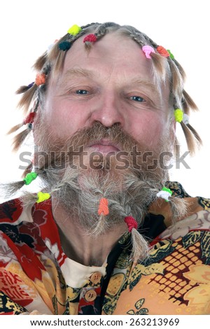 close-up portrait of a man with braids, mustache and beard in colored shirt on a white background studio