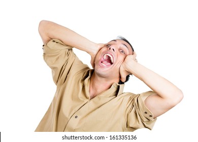 Closeup Portrait Of Man Going Nuts, Freaking Out, Mad, Wacky, Closing Ears Being Silly, Isolated On White Background. Negative Emotion Facial Expressions.