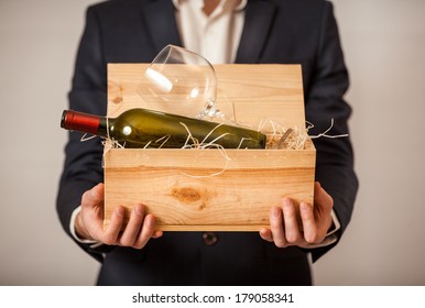 Closeup Portrait Of Man In Jacket Holding Open Box With Bottle Of Wine