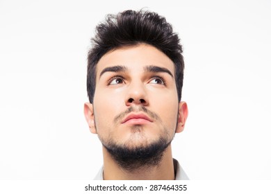 Closeup portrait of a man looking up at copyspace isolated on a white background