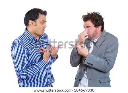 Closeup portrait, man looking at guy closing, covering nose, something stinks, very bad smell, odor. Male asks me? Isolated white background. Negative human emotion, facial expression, feeling