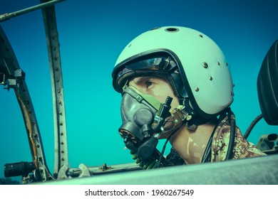 Close-up Portrait Of A Man Pilot Wearing Helmet In Cockpit Of Fighter Jet. Military Aircraft.